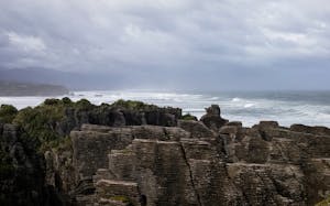 Dramatic view of Pancake Rocks along the rugged New Zealand coastline.