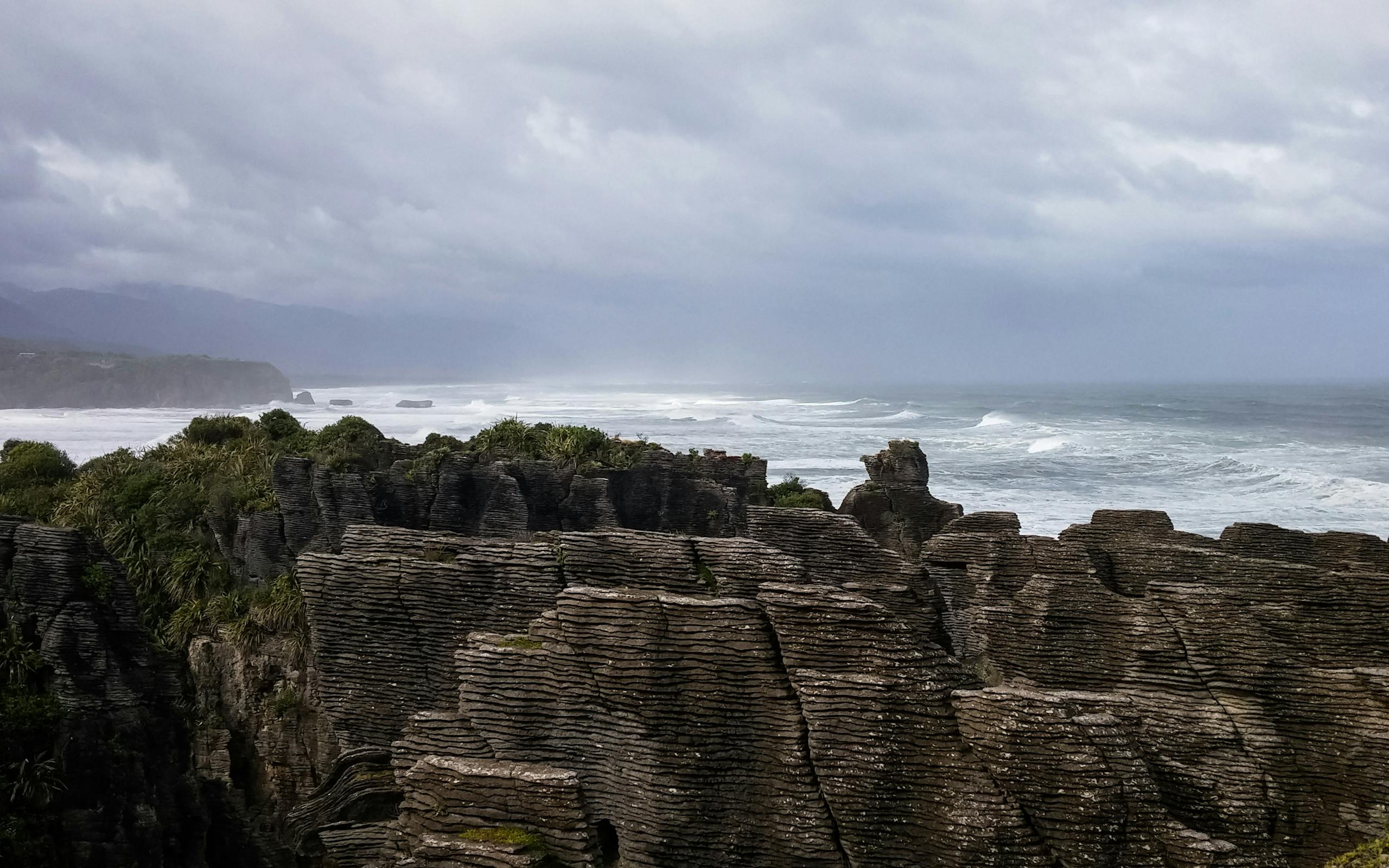 Dramatic view of Pancake Rocks along the rugged New Zealand coastline.